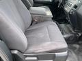 Front seats of a 2017 Ford Expedition with fabric upholstery and a center console between them