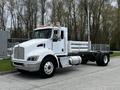 A white 2014 Kenworth T370 truck with a sleek design, featuring a prominent grille, chrome details, and an extended flatbed for cargo transport