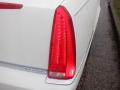 Close-up of the taillight of a 2008 Cadillac Limousine featuring a sleek design with red lighting elements and a chrome trim