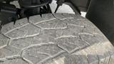 Close-up of a rugged tire tread on a 2013 RAM 2500 showing detailed grooves and wear patterns