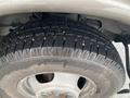 Close-up of a tire on a 2017 Chevrolet Express showing a tread pattern and wheel rim