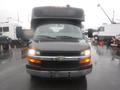 Front view of a black 2016 Chevrolet Express with a prominent hood and headlights and a boxy body design