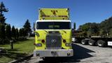 A bright yellow 1995 Freightliner FLL086 fire truck with a distinctive front design and chrome grille parked on a road