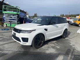 A 2020 Land Rover Range Rover Sport in white with black wheels parked with its hood slightly open