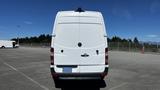 A white 2016 Mercedes-Benz Sprinter van seen from the rear with a high roof and no visible markings on the back doors