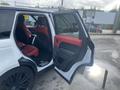 A 2020 Land Rover Range Rover Sport with red interior door panels open, revealing the back seating area and black trim details