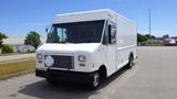 A 2011 Ford Econoline box truck with a white exterior and a flat front design parked on a pavement