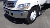 A white 2009 Hino 268 truck with a chrome front bumper and a single wheel visible at the front, featuring a clean tire with visible tread patterns