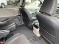 Interior view of a 2013 Toyota Sienna showcasing the rear seating area with two captain chairs and a console between them