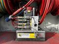 A hydraulic power unit with color-coded hoses and controls labeled for operation connected to rescue tools