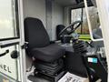 The interior of a 2007 Tennant Sentinel showing a driver's seat with a black upholstered cushion and a steering wheel with controls