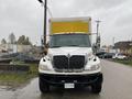 2018 International 26 Foot Cube Air Brakes truck facing forward with a large yellow cargo box and a prominent black grill