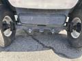 Close-up of the rear axle and wheels of a 1999 Ez-go Industrial golf cart showing the suspension and tire details