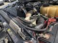 Close-up view of the engine compartment of a 2010 Ford F-550 with visible components like the turbo diesel engine and various hoses and wires