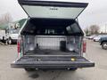 A 2014 Ford F-150 with an open tailgate and a view of the spacious truck bed