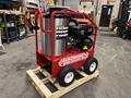 A red and silver 2024 Magnum 4000 Hot Water Pressure Washer mounted on a wooden pallet with a large water tank and engine visible