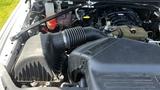 A close-up view of the engine compartment of a 2019 RAM 3500 highlighting the air intake system and various engine components