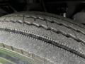 Close-up of a worn tire from a 2008 Ford F-750 showcasing tread patterns and surface wear