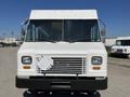 A white 2012 Ford Econoline van with a flat front and large windshield featuring two headlights and a prominent grille