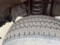 Close-up of a rugged tire tread on a 2011 Ford F-250 SD showcasing detailed patterns and grooves designed for traction and stability