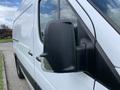 A white 2017 Mercedes-Benz Sprinter van with a large side mirror in focus