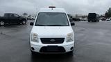 White 2012 Ford Transit van facing forward with a light bar on the roof and a black license plate area