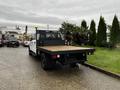 A 2020 Ford F-350 SD with a flatbed and safety light on top parked on a lot