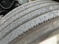 Close-up of a tire from a 2007 International 4300 showing deep treads with some dust and wear on the surface