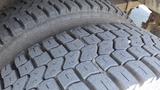 Close-up view of the tread on a large tire from a 2011 Ford Econoline showing deep grooves and rugged texture