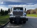 A white 2011 International 7500 truck with a prominent black grill and a snow plow attachment at the front