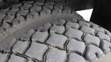 Close-up of a rugged tire from a 2008 International 7500 showcasing deep treads designed for traction and durability