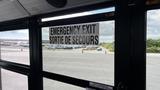 A 2014 Freightliner Thomas Diesel bus interior featuring an emergency exit sign in English and French