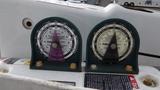 Close-up of two pressure gauges on a 2008 International 7500 showing readings with moving indicators on a white panel