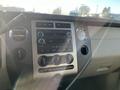 The image shows the dashboard of a 2013 Ford Expedition featuring controls for the audio system climate control and a display panel