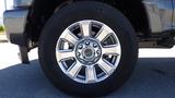 Close-up of a silver alloy wheel from a 2017 Ford F-350 SD featuring five double spokes and a Michelin tire mounted on it