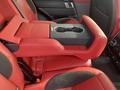 A 2020 Land Rover Range Rover Sport with red leather seats and a central console featuring cup holders