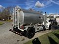 A 2013 Kenworth T370 fuel tanker truck with a shiny aluminum tank labeled diesel and equipped with a single exhaust pipe and rear lights