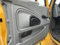 The image shows the interior door panel of a 2007 International 4300 featuring a textured gray finish a black handle and a small black panel with a label