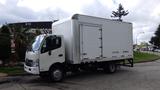 A 2016 Hino 195 box truck with a white exterior and a rear cargo door positioned on a street