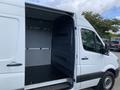 A 2017 Mercedes-Benz Sprinter van with an open rear door revealing a spacious empty cargo area