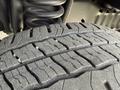 Close-up of a worn tire tread on a 2010 Ford Econoline showing detailed grooves and patterns indicative of use