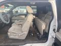 Interior of a 2009 Ford F-150 showing front and rear seats with cloth upholstery and a center console in a partially empty cabin