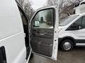 A 2009 Chevrolet Express van with an open driver's side door showcasing the interior door panel and controls