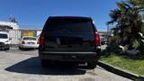 A black 2018 Chevrolet Tahoe is parked facing forward showing its rear details including the tail lights and bumper