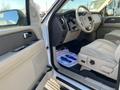 Interior view of a 2013 Ford Expedition showing the dashboard and driver’s seat with beige upholstery and steering wheel