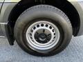 Close-up of a 2021 Mercedes-Benz Sprinter wheel featuring a silver rim with ventilation holes and a black tire with tread design