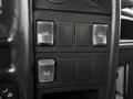 Close-up of vehicle control switches including headlight, windshield wiper, and auxiliary functions in a 2005 GMC C5 Duramax dashboard