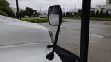 Close-up of the side mirror on a 2010 International 4300 truck with a white exterior and a sleek design