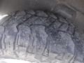 Close-up of a rugged tire with deep treads designed for off-road performance on a 2019 RAM 1500 Classic Eco Diesel