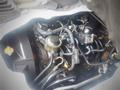 A 2003 Toyota Toyoace engine visible with various pipes and components including a cap and a throttle body